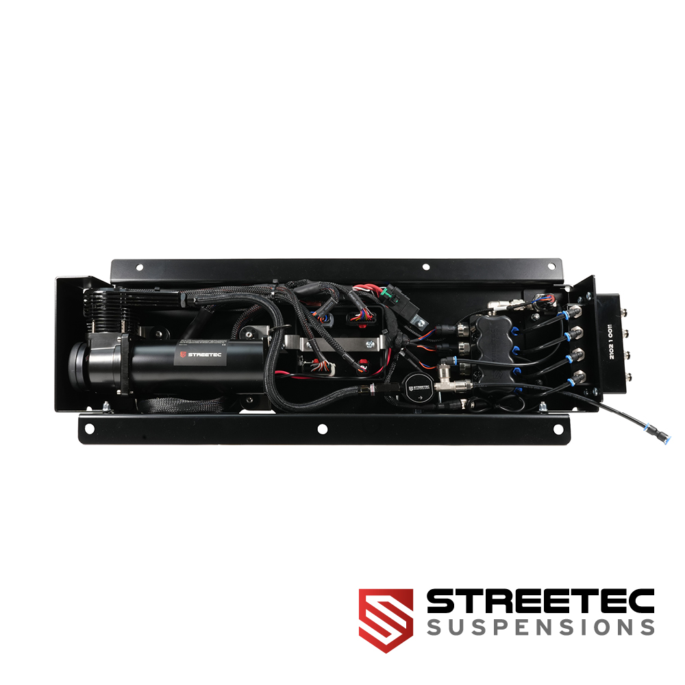 STREETEC air suspension system with compressor, valves and hoses in black housing, top-down view